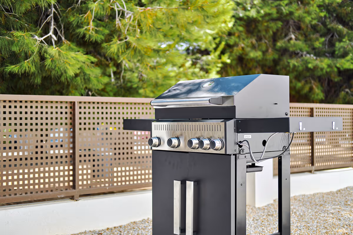 A BBQ grill in a backyard.